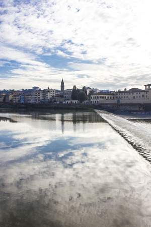 FLORENCE, ITALY - NOVEMBER 25 2015: Beautiful reflection in water of the sky, on Florence Arno riverのeditorial素材