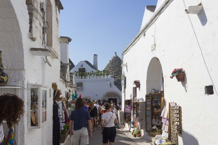 ALBEROBELLO, ITALY - AUGUST 27 2017: People in the traditional streets of Alberobello, Italy, in summer timesのeditorial素材