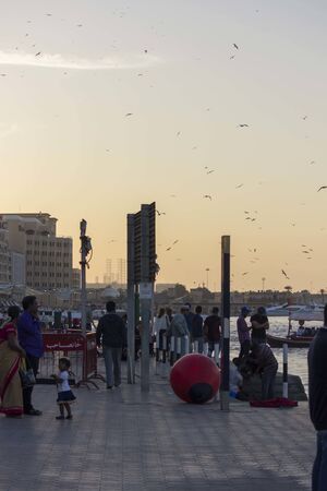 DUBAI, UAE - DECEMBER 30 2017: people walking at sunset on Dubai Creekのeditorial素材