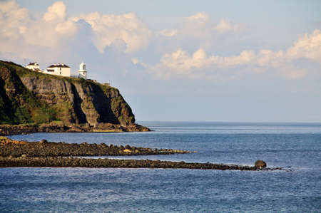 Irish white ighthouse on Antrim Coast, Northern Irelandの写真素材