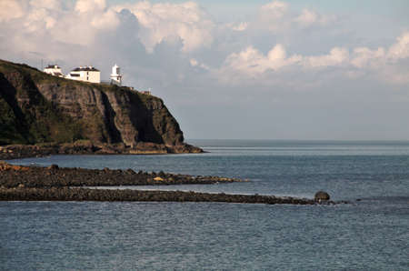Irish lwhite ighthouse on Antrim Coast, Northern Irelandの写真素材