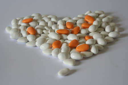 white and orange wedding comfits heart shapeの写真素材