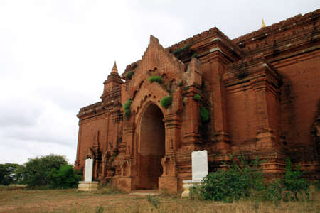 Ancient buddhist temple in Bagan with grey sky and clouds, Myanmarの写真素材