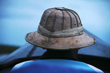 myanmar man on a boat in the blueの写真素材