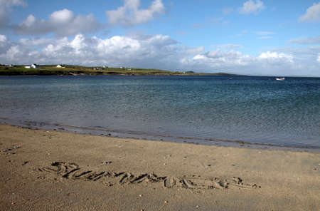Irish seaside landscape in St. John's Point in Donegal with the word summer type on the wet sandの写真素材