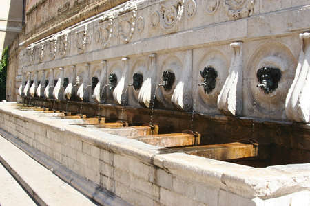 Historical fountain in Ancona, made by marble with bronze facesの写真素材