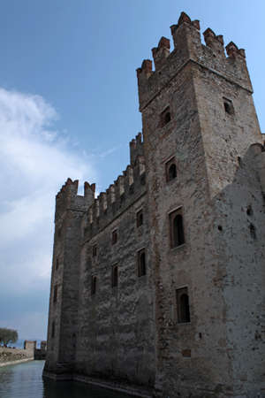 external side with high tower of Sirmione Castle on Garda lake, northern Italyのeditorial素材