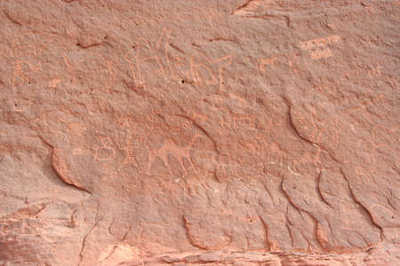 prehistoric engravings on a red stone in Wadi Rum desert, Jordanの写真素材