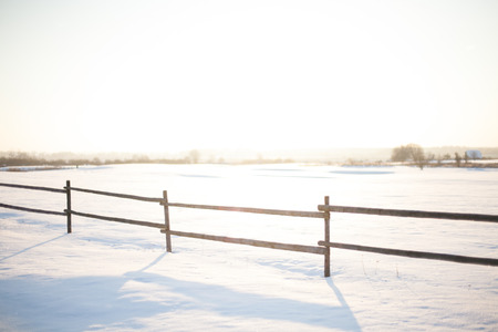 Sunset in the rural countryside with a bright sun halo on a cold winter's nightの写真素材