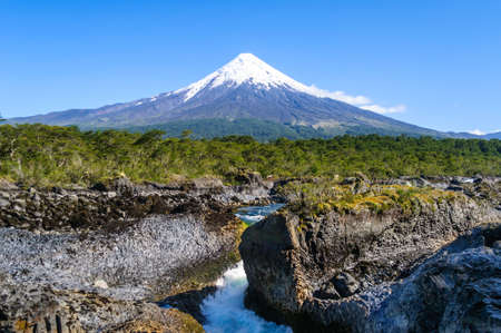 Petrohue waterfalls and volcano Osorno on background. Osorno is stratovolcano in Los Lagos Region of Chile. Osorno is one of the most active volcanoes of the southern Chilean Andes, Patagonia, Chileの写真素材