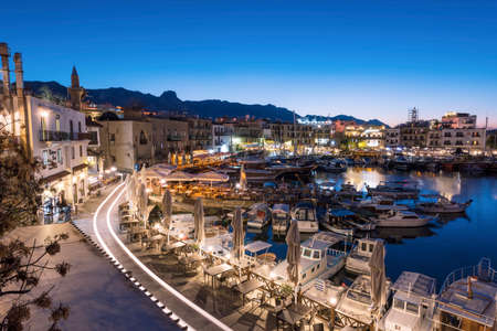 KYRENIA (GIRNE), NORTH CYPRUS - DECEMBER 19, 2016: Scenic night view of Kyrenia harbour with mountains on background. Kyrenia (Girne) harbour is one of the most popular tourist attractions in Cyprus.のeditorial素材