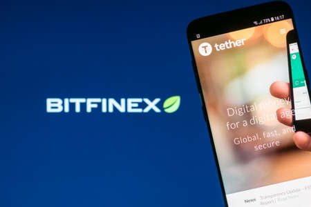 KYRENIA, CYPRUS - OCTOBER 3, 2018: Tether cryptocurrency website screen on blurred Bitfinex logo on backgroundのeditorial素材