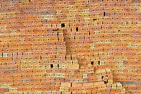 New red brick pavers stacked in rows like wall