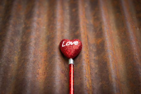 grunge valentine background with abstract heart on rusted galvanized iron plateの写真素材