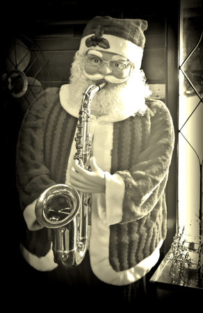Doll of Santa Claus playing saxophone. Christmas theme imageの写真素材