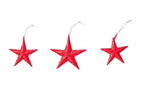 Red star shaped Christmas ornament on white background.の写真素材