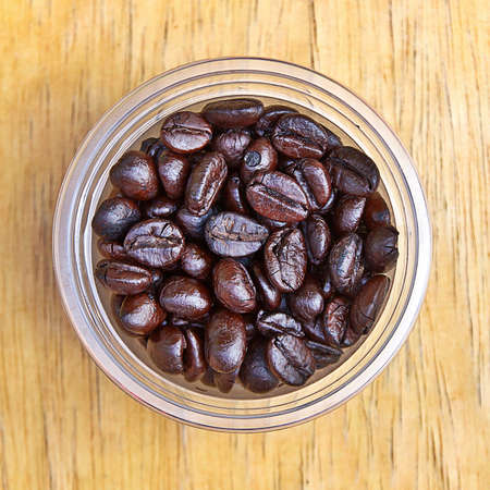 Coffee beans in plastic cup.の写真素材