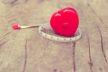 Love gauge concept. Red cartridges meters with heart shaped on wooden background.の写真素材