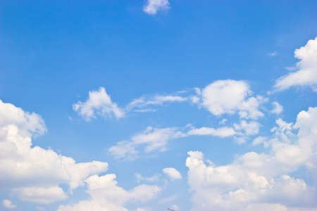 Blue sky background with clouds and sunshine.の写真素材