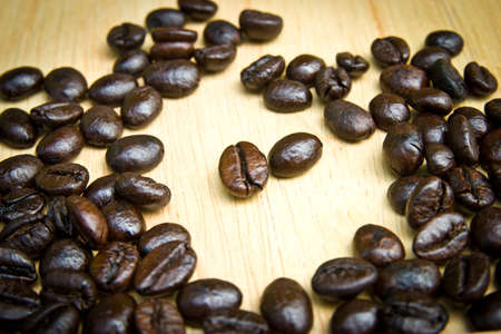 Coffee beans on wood backgroundの写真素材