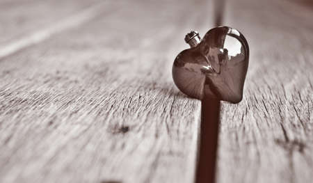 Black and white photo of heart on wood background.の写真素材