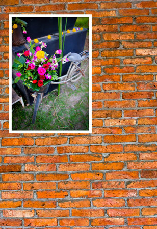 Vintage bicycle with flowers photo on brick wall.Home Decor Ideas.の写真素材