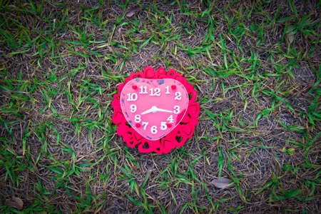 Valentines day background with red clock shaped heart.の写真素材