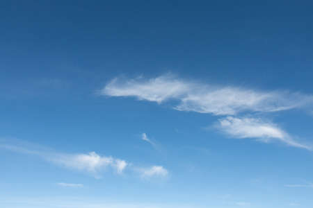 Several thin white clouds floating in the blue sky.の写真素材