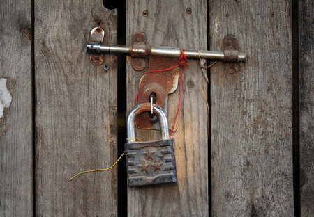 Iron padlock on a rusty latch