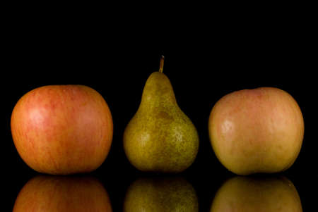 Apples and pear on black backgroudnの写真素材