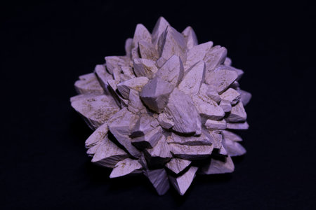 Close-up of crystalline aragonite crystals isolated on black background.