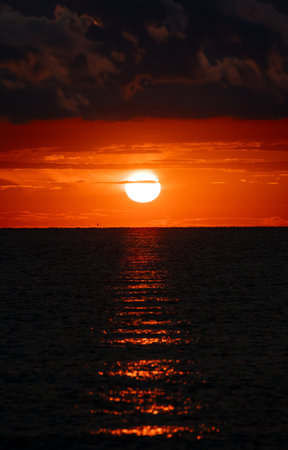 Beautiful sunset over the sea. The sun goes down over the sea.の写真素材