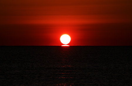 Sunset over the sea. Red sunset over the sea. Beautiful sunset over the sea.の写真素材