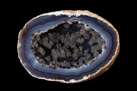 Macro photo of agate mineral isolated on a black background.の写真素材