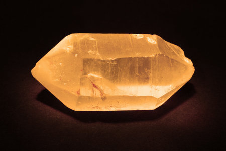 Amber crystal on a black background. Selective focus. Toned.の写真素材