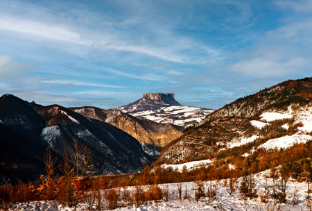 Mountain landscape in winter. The breathtaking beauty of the Tuscan-Emilian Apennine hills with Bismantova Rock in the distanceの写真素材