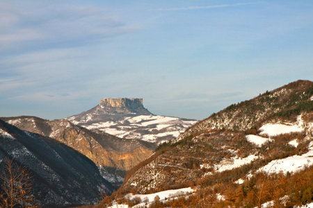 Mountain landscape in winter. The breathtaking beauty of the Tuscan-Emilian Apennine hills with Bismantova Rock in the distanceの写真素材