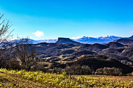 Mountain landscape with snow and blue sky. The Breathtaking Beauty of the Tuscan-Emilian Apennine Hills with Bismantova Rock in the Distanceの写真素材