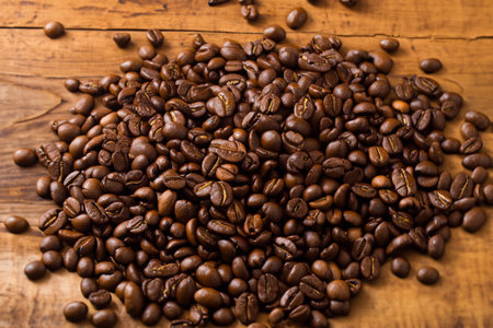 Roasted coffee beans on wooden background. Top view, copy spaceの写真素材