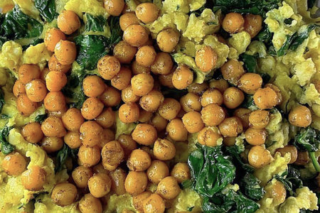 Fried yellow chickpeas with spinach. Top views. Healthy food.の写真素材