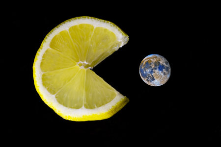 Lemon and planet on a black background. The concept of healthy eating.の写真素材