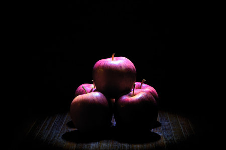 Three red apples on a dark background. Close-up. Selective focus.の写真素材