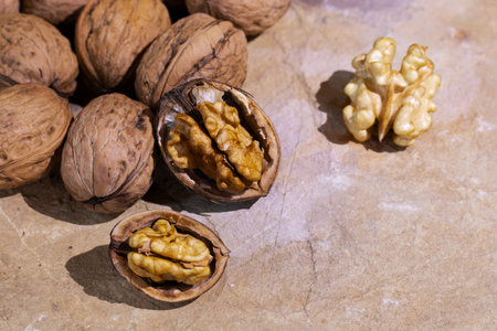 Walnuts in shell and whole walnuts in shell backgroundの写真素材