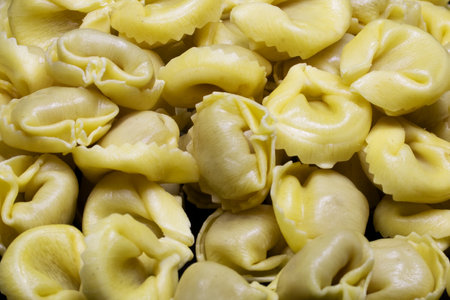 closeup of italian tortellini pasta on the black backgroundの写真素材