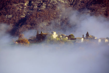 Landscape of foggy morning at the mountain village in Slovenia.の写真素材