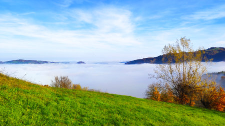 Panoramic view of foggy morning in the mountains. Nature composition.の写真素材