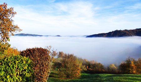 Autumn landscape with fog in the mountains. Beautiful nature background.の写真素材