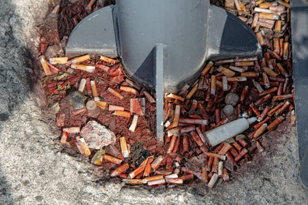 Close-up of a pile of used batteries on the ground.