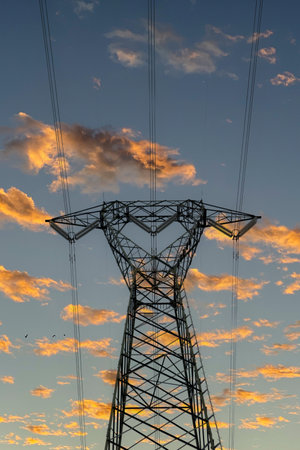 High voltage power pylons and beautiful sky at sunset background.の写真素材