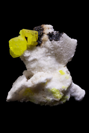 snowman on a black background with a yellow and green stone